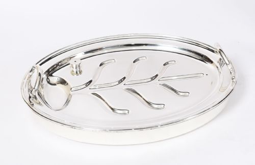 fig 6. An Art Deco silver-plated beef carving trolley with a hemispherical revolving dome cover mounted on a dark mahogany frame with cabriole legs.