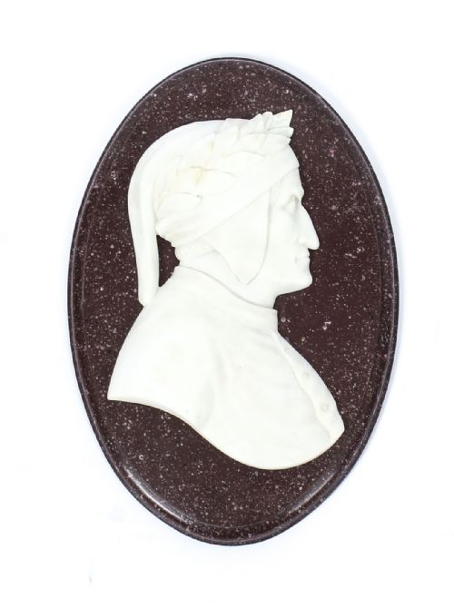 fig 1. A pair of 19th-century oval plaques featuring white carved marble profile busts of Dante and Virgil set against dark mottled stone backgrounds.