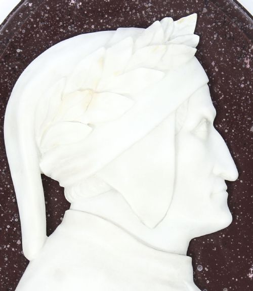 fig 2. A pair of 19th-century oval plaques featuring white carved marble profile busts of Dante and Virgil set against dark mottled stone backgrounds.