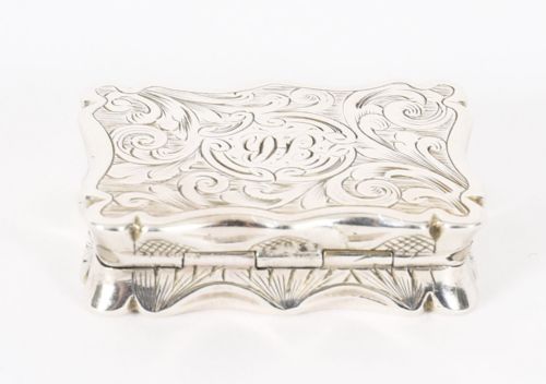 fig 3. An open Victorian sterling silver vinaigrette displaying a scalloped edge and a hinged floral pierced gilt interior grille.