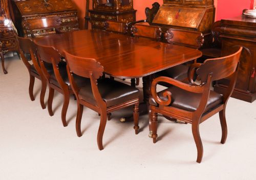fig 2. A George III Regency period mahogany twin pillar dining table featuring reeded edge detail and tripod pedestal legs with brass castors.