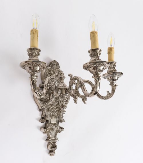 fig 2. A pair of ornate silver-plated French wall sconces with three scrolling candle arms and detailed acanthus leaf decoration.
