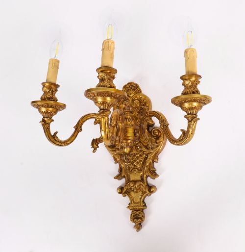fig 1. A set of eight French gilt bronze three-arm wall appliques featuring ornate foliate castings and candle-style fittings.