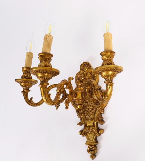 fig 2. A set of eight French gilt bronze three-arm wall appliques featuring ornate foliate castings and candle-style fittings.