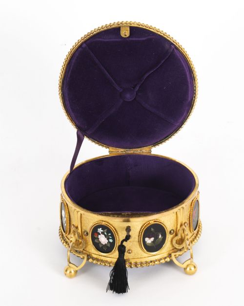 fig 2. A circular 19th-century ormolu jewellery casket featuring fine Pietra Dura floral and fruit stone inlays set into gilt bronze with a key and tassel.