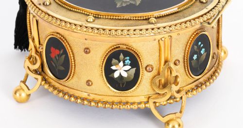 fig 6. A circular 19th-century ormolu jewellery casket featuring fine Pietra Dura floral and fruit stone inlays set into gilt bronze with a key and tassel.