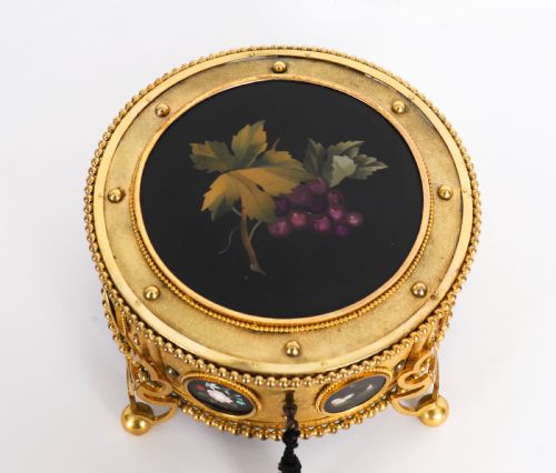 fig 8. A circular 19th-century ormolu jewellery casket featuring fine Pietra Dura floral and fruit stone inlays set into gilt bronze with a key and tassel.