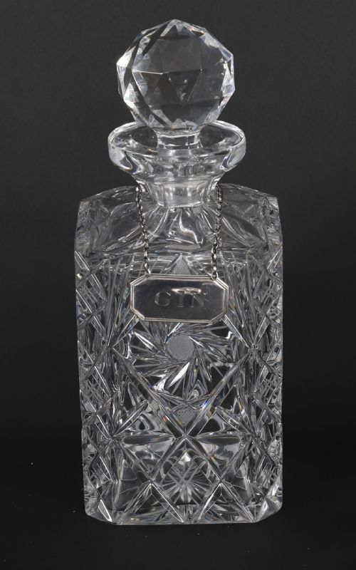 fig 5. An Edwardian Betjemanns coromandel wood tantalus with hallmarked silver mounts holding three cut-crystal decanters.