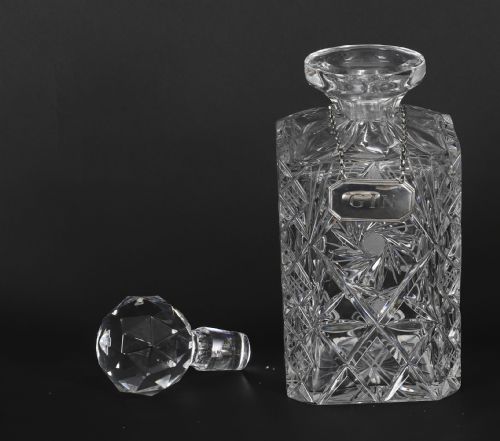 fig 7. An Edwardian Betjemanns coromandel wood tantalus with hallmarked silver mounts holding three cut-crystal decanters.