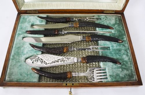 fig 1. A 19th-century Victorian silver-plated carving and serving set with dark stag antler handles, displayed inside a silk and velvet lined wooden canteen box.