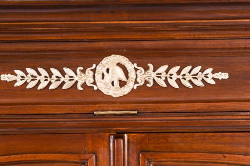 fig 6. A nineteenth-century French Empire Revival mahogany bookcase featuring twin glazed doors, gilt bronze mounts, a marble top, and metal paw feet.