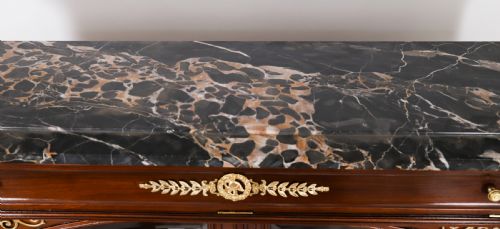 fig 9. A nineteenth-century French Empire Revival mahogany bookcase featuring twin glazed doors, gilt bronze mounts, a marble top, and metal paw feet.