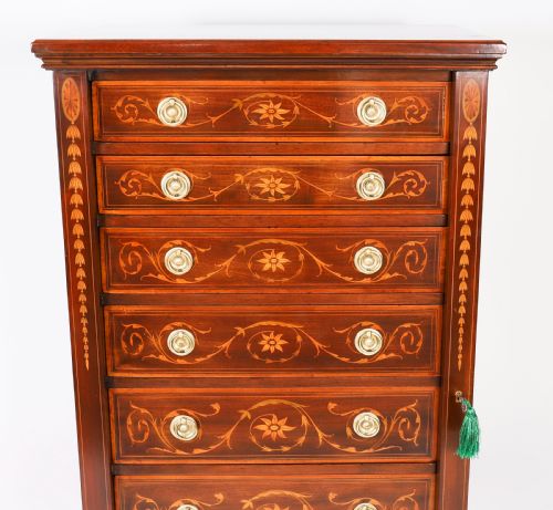 fig 3. An Edwardian mahogany Wellington chest featuring eight inlaid drawers, satinwood floral motifs, a right-side locking stile, and brass handles.