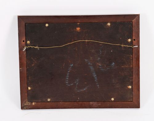 fig 5. A dark wooden moulding frame housing six white plaster classical intaglio impressions set against a dark brown velvet background.