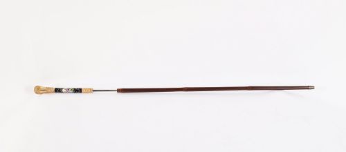 fig 2. A 19th-century French sword stick featuring a chased gold-plated pommel and a hand-painted Sevres style cobalt blue porcelain collar above a wooden shaft with a partially drawn steel blade.