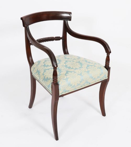 fig 2. A set of eight Regency mahogany dining chairs, including two carvers, featuring curved top rails, rope-twist splats, and pale blue patterned upholstered seats.