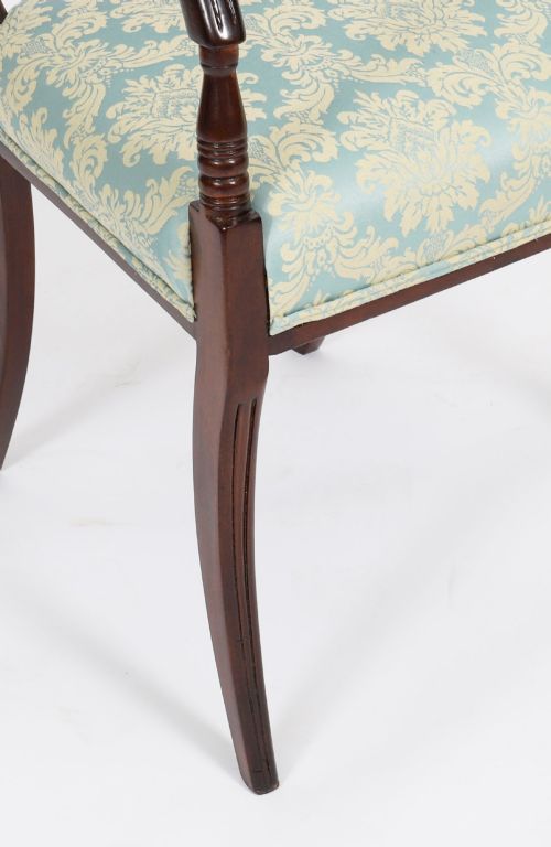 fig 4. A set of eight Regency mahogany dining chairs, including two carvers, featuring curved top rails, rope-twist splats, and pale blue patterned upholstered seats.