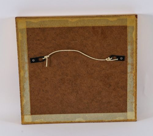 fig 6. A pair of framed displays containing white plaster intaglio relief medallions mounted on green patterned fabric inside gilt frames.