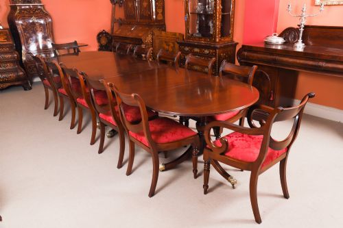 fig 3. An extended mahogany Regency Revival triple pillar dining table with reeded legs and brass paw castors.