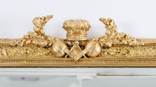 fig 1. A rectangular nineteenth-century gold giltwood mirror featuring carved Masonic emblems, floral mouldings, and a crest.
