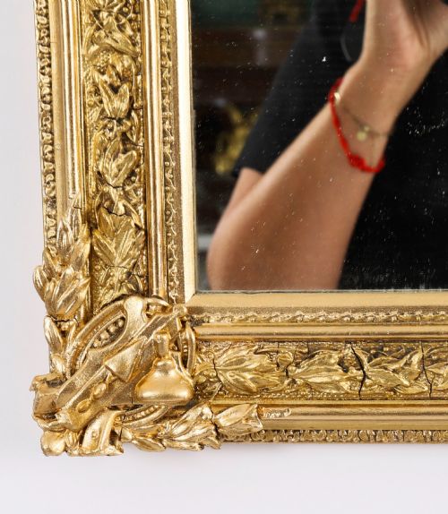 fig 2. A rectangular nineteenth-century gold giltwood mirror featuring carved Masonic emblems, floral mouldings, and a crest.