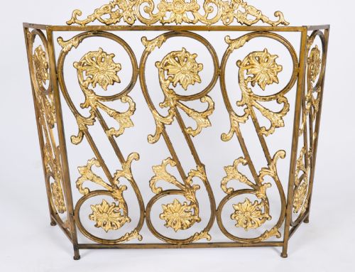 fig 1. A nineteenth-century French Louis XIV Revival three-panel folding fire screen made from gilt brass featuring intricate floral scrollwork and an ornate cresting motif.
