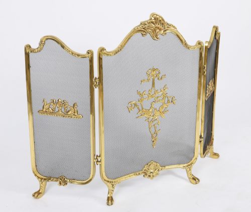 fig 1. A three-fold French Rococo gilt bronze fire screen featuring fine wire mesh panels, ornate scrollwork cresting, and a central flaming torch motif.
