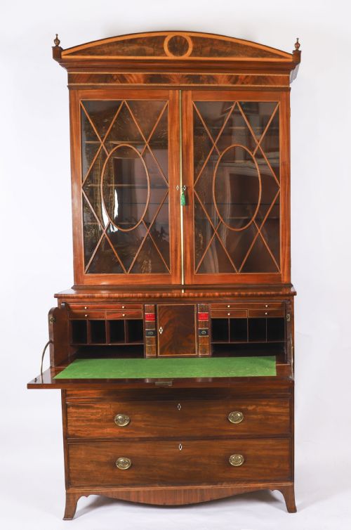 fig 1. A George III flame mahogany secretaire bookcase featuring an arched pediment, astragal glazed doors, and lower drawers on bracket feet.