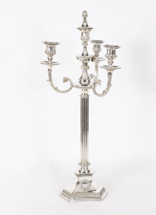 fig 1. A pair of silver-plated four-light candelabra with fluted columns, scroll branches, and laurel wreath detailing on square bases.