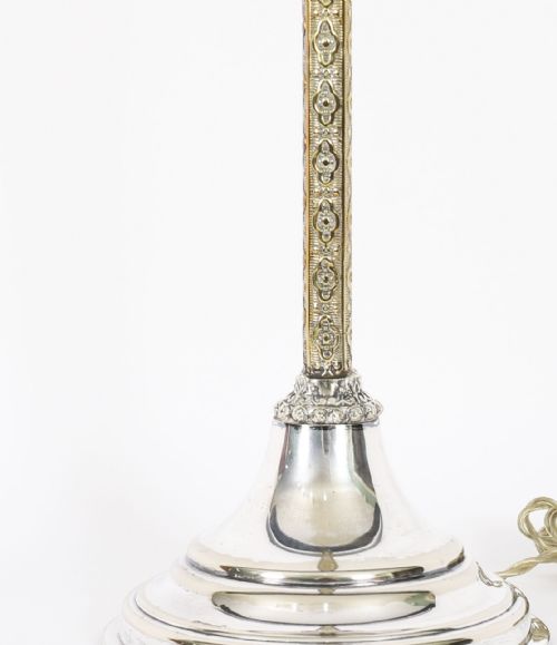 fig 2. A nineteenth-century silver-plated table lamp base with a parcel gilt patterned column and stepped circular foot.