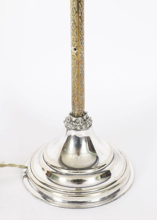 fig 4. A nineteenth-century silver-plated table lamp base with a parcel gilt patterned column and stepped circular foot.