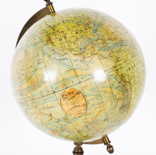 fig 1. An antique 1880 French terrestrial globe mounted on a brass half-meridian ring and a decorative cast metal tripod base.