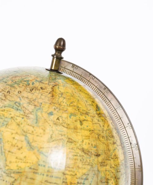 fig 3. An antique 1880 French terrestrial globe mounted on a brass half-meridian ring and a decorative cast metal tripod base.