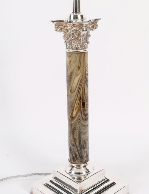 fig 1. A silver-plated Corinthian column table lamp with a marbled shaft set upon a stepped square base.