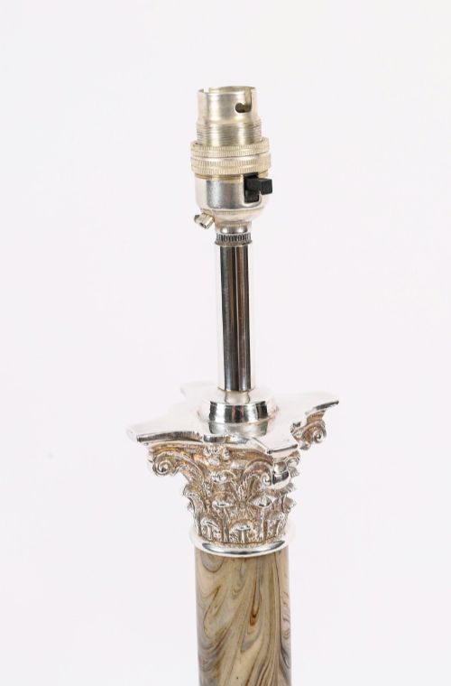 fig 3. A silver-plated Corinthian column table lamp with a marbled shaft set upon a stepped square base.