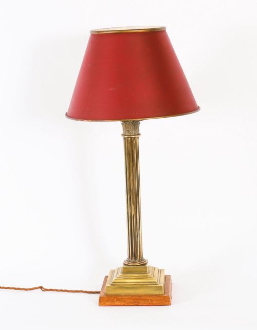 fig 2. A pair of late nineteenth-century brass Corinthian column table lamps featuring fluted stems, stepped bases, wooden plinths, and conical red lampshades.