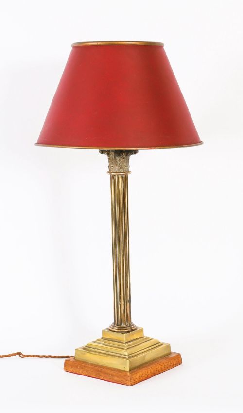 fig 3. A pair of late nineteenth-century brass Corinthian column table lamps featuring fluted stems, stepped bases, wooden plinths, and conical red lampshades.