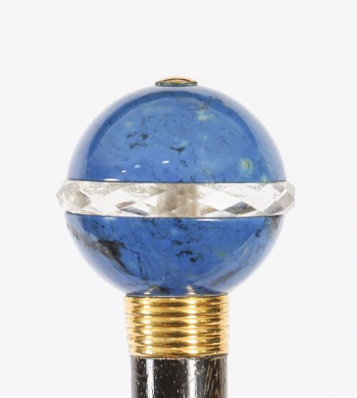 fig 4. An Edwardian walking cane featuring a spherical lapis lazuli pommel accented with a faceted crystal band and a ribbed gold collar on a dark hardwood shaft.