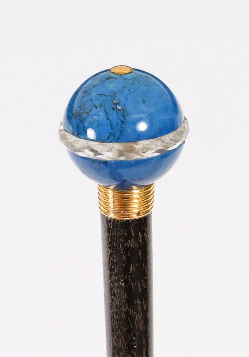 fig 7. An Edwardian walking cane featuring a spherical lapis lazuli pommel accented with a faceted crystal band and a ribbed gold collar on a dark hardwood shaft.