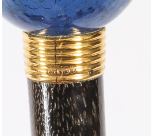 fig 8. An Edwardian walking cane featuring a spherical lapis lazuli pommel accented with a faceted crystal band and a ribbed gold collar on a dark hardwood shaft.