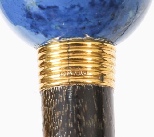 An Edwardian walking cane featuring a spherical lapis lazuli pommel accented with a faceted crystal band and a ribbed gold collar on a dark hardwood shaft. View X