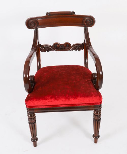 fig 2. A set of ten Regency flame mahogany dining chairs with carved scroll backrails, turned fluted front legs, and red velvet seats.