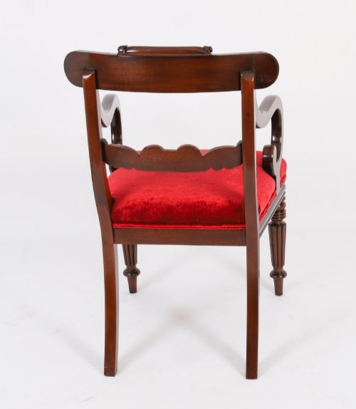 fig 6. A set of ten Regency flame mahogany dining chairs with carved scroll backrails, turned fluted front legs, and red velvet seats.