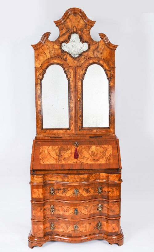 fig 1. An 18th-century Venetian burr walnut bureau bookcase featuring a shaped top pediment with mirrored inset, twin mirrored cabinet doors, a slant-front writing slope, and three serpentine drawers.