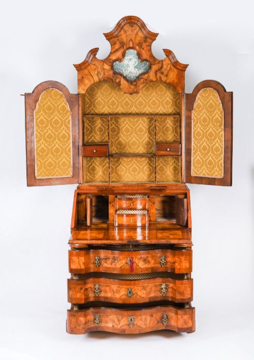 fig 2. An 18th-century Venetian burr walnut bureau bookcase featuring a shaped top pediment with mirrored inset, twin mirrored cabinet doors, a slant-front writing slope, and three serpentine drawers.