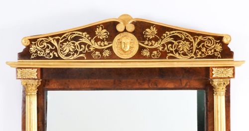 fig 1. A nineteenth-century rectangular French burr walnut mirror featuring gilded fluted pilasters, classical foliate cresting with a central mask motif, and gilt rosettes.