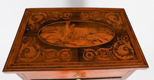 fig 3. An 18th-century Italian Neoclassical walnut commodino featuring intricate foliate and pictorial marquetry inlay, three drawers with lion head ring pulls, and square tapered legs.