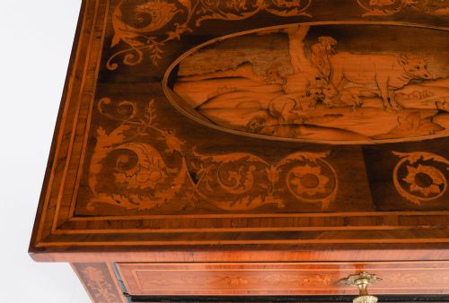 fig 4. An 18th-century Italian Neoclassical walnut commodino featuring intricate foliate and pictorial marquetry inlay, three drawers with lion head ring pulls, and square tapered legs.
