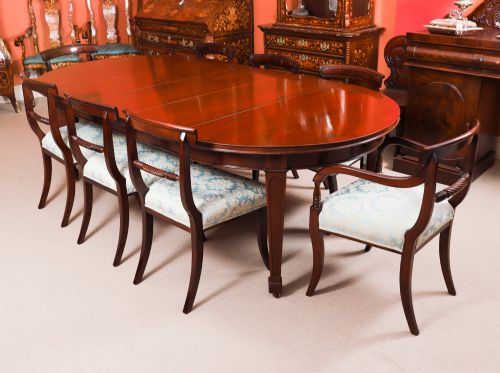 fig 2. An antique Victorian oval extending dining table crafted from flame mahogany with tapered legs on brass castors.