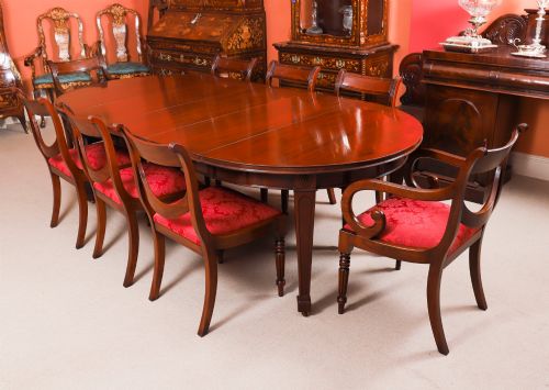 fig 3. An antique Victorian oval extending dining table crafted from flame mahogany with tapered legs on brass castors.
